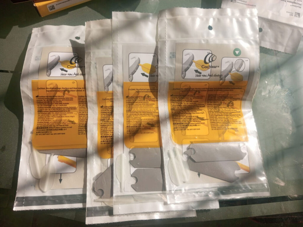 Cochlear implant cables in their original bag