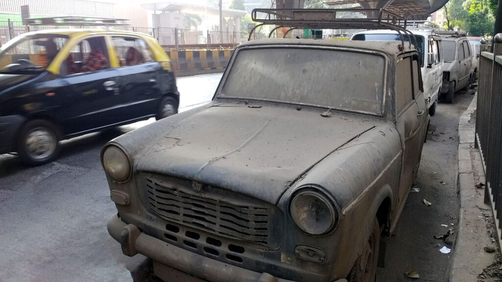 Dusty Padmini discarded by the side of the road.