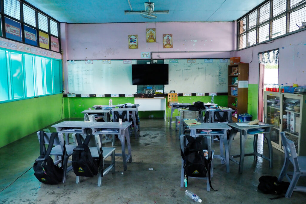 The DLTV classroom has a simple setup, with students following along and taking notes on the TV-based teaching